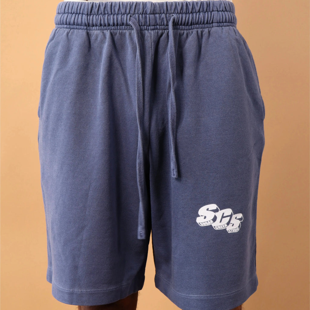 Blue shorts with a logo on a beige background