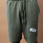 Green shorts with a logo on a beige background