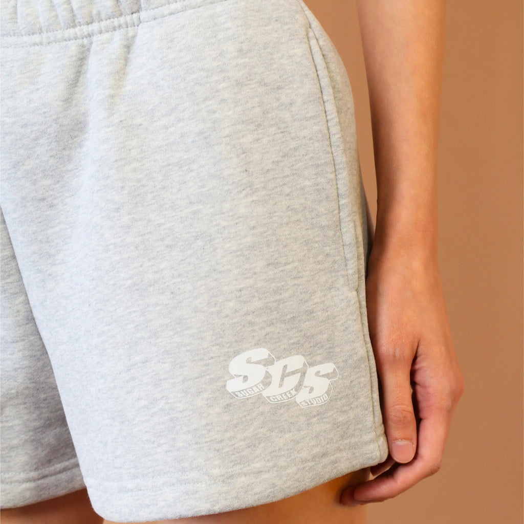 Gray shorts with a logo on a beige background